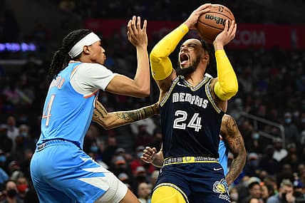 Jan 8, 2022; Los Angeles, California, USA; Memphis Grizzlies forward Dillon Brooks (24) reacts suffering an injury while moving to the basket against Los Angeles Clippers guard Brandon Boston Jr. (4) during the first half at Crypto.com Arena. Mandatory Credit: Gary A. Vasquez-USA TODAY Sports