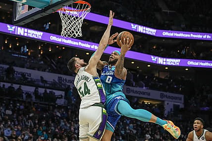 Jan 8, 2022; Charlotte, North Carolina, USA; Charlotte Hornets forward Miles Bridges (0) drives to the basket against Milwaukee Bucks forward Sandro Mamukelashvili (54) during the second period at the Spectrum Center. Mandatory Credit: Jim Dedmon-USA TODAY Sports