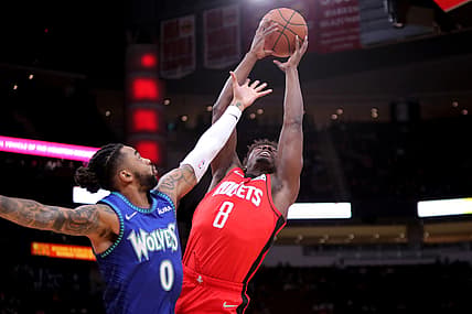Jan 9, 2022; Houston, Texas, USA; Houston Rockets forward Jae'Sean Tate (8) and Minnesota Timberwolves guard D'Angelo Russell (0) battle for a rebound during the first quarter at Toyota Center. Mandatory Credit: Erik Williams-USA TODAY Sports