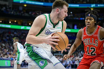 Jan 9, 2022; Dallas, Texas, USA; Dallas Mavericks guard Luka Doncic (77) grabs a rebound in front of Chicago Bulls guard Ayo Dosunmu (12) during the second quarter at the American Airlines Center. Mandatory Credit: Jerome Miron-USA TODAY Sports