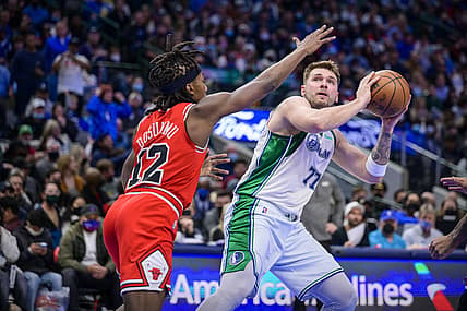 Jan 9, 2022; Dallas, Texas, USA; Chicago Bulls guard Ayo Dosunmu (12) defends against Dallas Mavericks guard Luka Doncic (77) during the second half at the American Airlines Center. Mandatory Credit: Jerome Miron-USA TODAY Sports