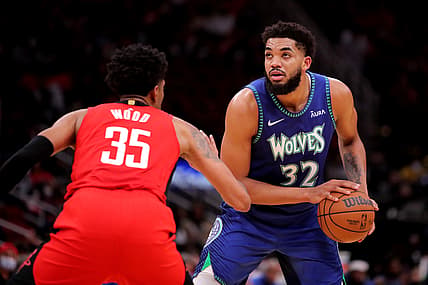 Jan 9, 2022; Houston, Texas, USA; Minnesota Timberwolves center Karl-Anthony Towns (32) handles the ball outside while Houston Rockets center Christian Wood (35) defends during the third quarter at Toyota Center. Mandatory Credit: Erik Williams-USA TODAY Sports