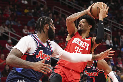 Jan 10, 2022; Houston, Texas, USA; Houston Rockets center Christian Wood (35) shoots against Philadelphia 76ers center Andre Drummond (1) in the second quarter at Toyota Center. Mandatory Credit: Thomas Shea-USA TODAY Sports