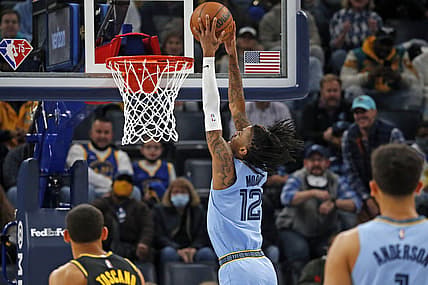 Jan 11, 2022; Memphis, Tennessee, USA; Memphis Grizzles guard Ja Morant (12) dunks the ball during the first half against the Golden State Warriors at FedExForum. Mandatory Credit: Petre Thomas-USA TODAY Sports