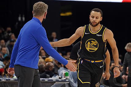 Jan 11, 2022; Memphis, Tennessee, USA; Golden State Warriors guard Stephen Curry (30) celebrates with head coach Steve Kerr (left) after a basket during the second half against the Memphis Grizzles at FedExForum. Mandatory Credit: Petre Thomas-USA TODAY Sports