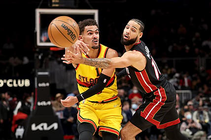 Jan 12, 2022; Atlanta, Georgia, USA; Atlanta Hawks guard Trae Young (11) passes out of the defense of Miami Heat forward Caleb Martin (16) during the third quarter at State Farm Arena. Mandatory Credit: Jason Getz-USA TODAY Sports