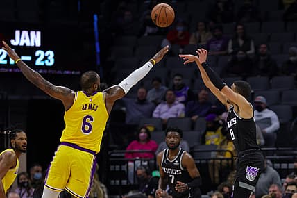 Jan 12, 2022; Sacramento, California, USA; Sacramento Kings guard Tyrese Haliburton (0) shoots the ball over Los Angeles Lakers forward LeBron James (6) during the second quarter at Golden 1 Center. Mandatory Credit: Sergio Estrada-USA TODAY Sports