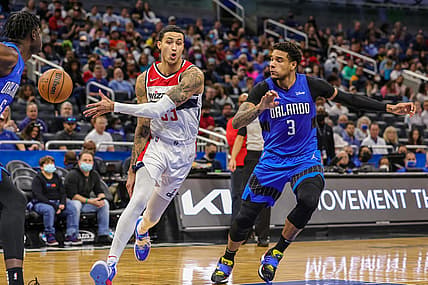 Jan 9, 2022; Orlando, Florida, USA; Washington Wizards forward Kyle Kuzma (33) passes the ball against Orlando Magic forward Chuma Okeke (3) during the second quarter at Amway Center. Mandatory Credit: Mike Watters-USA TODAY Sports