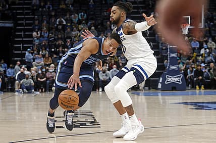 Jan 13, 2022; Memphis, Tennessee, USA; Memphis Grizzles guard Desmond Bane (22) drives to the basket as Minnesota Timberwolves guard D'Angelo Russell (0) defends during the second half at FedExForum. Mandatory Credit: Petre Thomas-USA TODAY Sports