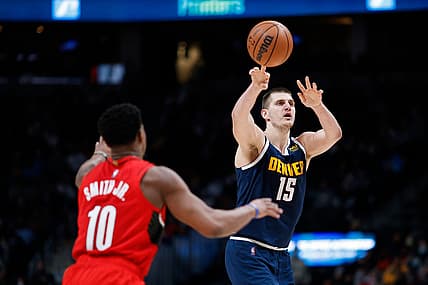 Jan 13, 2022; Denver, Colorado, USA; Denver Nuggets center Nikola Jokic (15) passes the ball over Portland Trail Blazers guard Dennis Smith Jr. (10) in the second quarter at Ball Arena. Mandatory Credit: Isaiah J. Downing-USA TODAY Sports