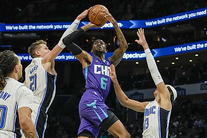Jan 14, 2022; Charlotte, North Carolina, USA; Charlotte Hornets forward Jalen McDaniels (6) tries to fight pressure from  Orlando Magic guard R.J. Hampton (13) and center Moritz Wagner (21) during the second quarter at the Spectrum Center. Mandatory Credit: Jim Dedmon-USA TODAY Sports