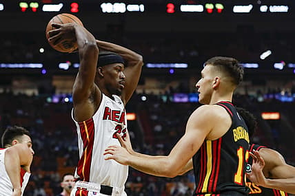 Jan 14, 2022; Miami, Florida, USA; Miami Heat forward Jimmy Butler (22) protects the ball from Atlanta Hawks guard Bogdan Bogdanovic (13) during the first quarter of the game at FTX Arena. Mandatory Credit: Sam Navarro-USA TODAY Sports