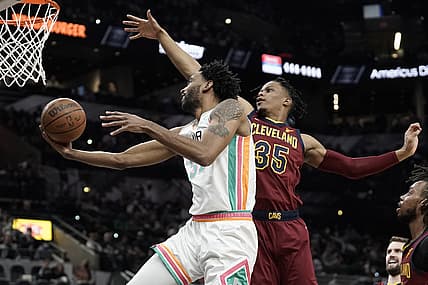 Jan 14, 2022; San Antonio, Texas, USA; San Antonio Spurs forward Keita Bates-Diop (3) lays in a basket while defended by Cleveland Cavaliers guard Isaac Okoro (35) during the first half at AT&T Center. Mandatory Credit: Scott Wachter-USA TODAY Sports
