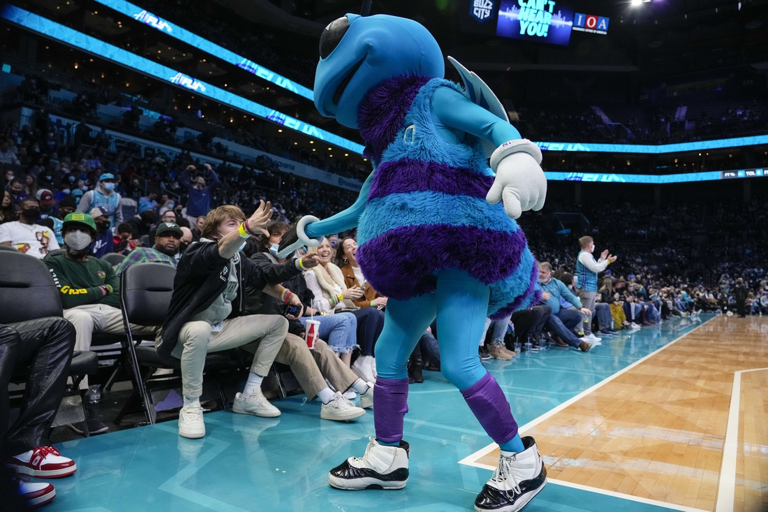 Jan 14, 2022; Charlotte, North Carolina, USA; Charlotte Hornets mascot high fives fans as he walks off the court during the second half between the Charlotte Hornets and the Orlando Magic at the Spectrum Center. Mandatory Credit: Jim Dedmon-USA TODAY Sports