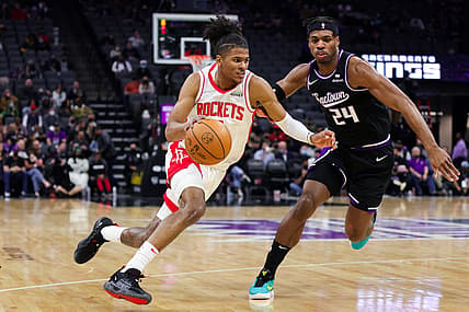 Jan 14, 2022; Sacramento, California, USA; Houston Rockets guard Jalen Green (0) dribbles the ball past Sacramento Kings guard Buddy Hield (24) during the second quarter at Golden 1 Center. Mandatory Credit: Sergio Estrada-USA TODAY Sports
