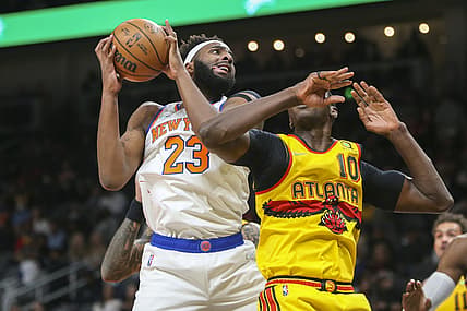 Jan 15, 2022; Atlanta, Georgia, USA; New York Knicks center Mitchell Robinson (23) grabs a rebound past Atlanta Hawks center Gorgui Dieng (10) in the first quarter at State Farm Arena. Mandatory Credit: Brett Davis-USA TODAY Sports