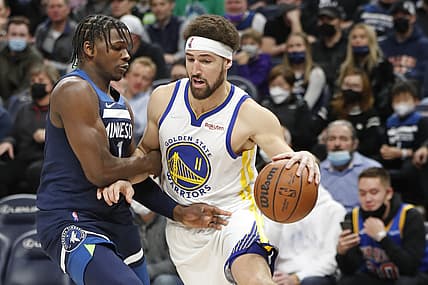 Jan 16, 2022; Minneapolis, Minnesota, USA; Golden State Warriors' Klay Thompson (11) dribbles around Minnesota Timberwolves forward Anthony Edwards (1) in the first quarter at Target Center. Mandatory Credit: Bruce Kluckhohn-USA TODAY Sports