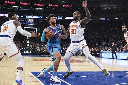 Jan 17, 2022; New York, New York, USA;  Charlotte Hornets forward Miles Bridges (0) drives past New York Knicks guard RJ Barrett (9) and forward Julius Randle (30) in the second quarter at Madison Square Garden. Mandatory Credit: Wendell Cruz-USA TODAY Sports