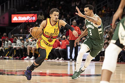 Jan 17, 2022; Atlanta, Georgia, USA; Atlanta Hawks guard Trae Young (11) drives against Milwaukee Bucks guard George Hill (3) during the first quarter at State Farm Arena. Mandatory Credit: Jason Getz-USA TODAY Sports