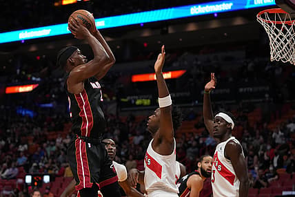 Jan 17, 2022; Miami, Florida, USA; Miami Heat forward Jimmy Butler (22) shoots the ball over Toronto Raptors forward OG Anunoby (3) and forward Pascal Siakam (43) during the first half at FTX Arena. Mandatory Credit: Jasen Vinlove-USA TODAY Sports