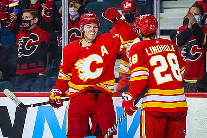 Jan 18, 2022; Calgary, Alberta, CAN; Calgary Flames left wing Matthew Tkachuk (19) scores a goal with center Elias Lindholm (28) against the Florida Panthers during the third period at Scotiabank Saddledome. Mandatory Credit: Sergei Belski-USA TODAY Sports