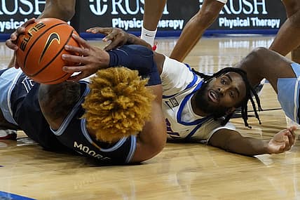 Jan 8, 2022; Chicago, Illinois, USA; Villanova Wildcats guard Justin Moore (5) and DePaul Blue Demons guard Javon Freeman-Liberty (4) go for the ball during the second half at Wintrust Arena. Mandatory Credit: David Banks-USA TODAY Sports