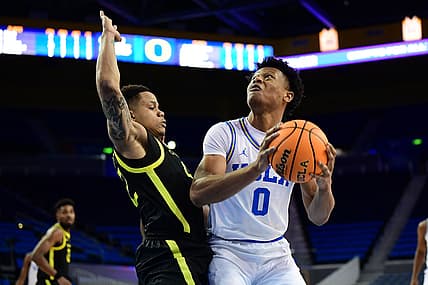 Jan 13, 2022; Los Angeles, California, USA; UCLA Bruins guard Jaylen Clark (0) moves to the basket against Oregon Ducks guard Jacob Young (42) during the second half at Pauley Pavilion. Mandatory Credit: Gary A. Vasquez-USA TODAY Sports