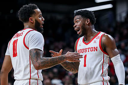 Feb 6, 2022; Cincinnati, Ohio, USA; Houston Cougars guard Kyler Edwards (11) reacts after a play with guard Jamal Shead (1) in the first half against the Cincinnati Bearcats at Fifth Third Arena. Mandatory Credit: Katie Stratman-USA TODAY Sports