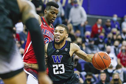 Feb 12, 2022; Seattle, Washington, USA; Washington Huskies guard Terrell Brown Jr. (23) dribbles against Arizona Wildcats center Christian Koloko (35) during the first half at Alaska Airlines Arena at Hec Edmundson Pavilion. Mandatory Credit: Joe Nicholson-USA TODAY Sports