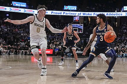 Feb 19, 2022; Winston-Salem, North Carolina, USA; Notre Dame Fighting Irish guard Blake Wesley (0) pulls up short guarded by Wake Forest Demon Deacons forward Jake LaRavia (0) during the second half at Lawrence Joel Veterans Memorial Coliseum. Mandatory Credit: Jim Dedmon-USA TODAY Sports