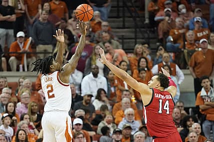 Feb 19, 2022; Austin, Texas, USA; Texas Longhorns guard Marcus Carr (2) shoots over Texas Tech Red Raiders forward Marcus Santos-Silva (14) during the second half at Frank C. Erwin Jr. Center. Mandatory Credit: Scott Wachter-USA TODAY Sports