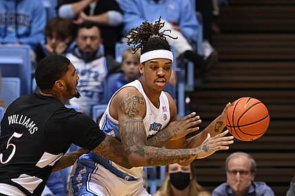 Feb 21, 2022; Chapel Hill, North Carolina, USA;  North Carolina Tar Heels forward Armando Bacot (5) with the ball as Louisville Cardinals forward Malik Williams (5) defends in the first half at Dean E. Smith Center. Mandatory Credit: Bob Donnan-USA TODAY Sports