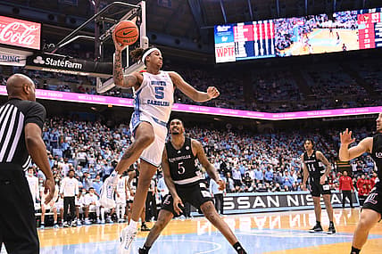 Feb 21, 2022; Chapel Hill, North Carolina, USA;  North Carolina Tar Heels forward Armando Bacot (5) looks to pass as Louisville Cardinals forward Malik Williams (5) defends in the second half at Dean E. Smith Center. Mandatory Credit: Bob Donnan-USA TODAY Sports