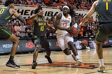 Feb 21, 2022; Stillwater, Oklahoma, USA; Oklahoma State Cowboys guard Isaac Likekele (13) controls the ball past Baylor Bears guard Adam Flagler (10) during the first half at Gallagher-Iba Arena. Mandatory Credit: Rob Ferguson-USA TODAY Sports
