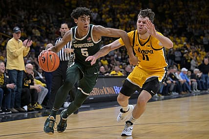 Feb 22, 2022; Iowa City, Iowa, USA; Michigan State Spartans guard Max Christie (5) goes to the basket as Iowa Hawkeyes forward Filip Rebraca (0) defends during the first half at Carver-Hawkeye Arena. Mandatory Credit: Jeffrey Becker-USA TODAY Sports