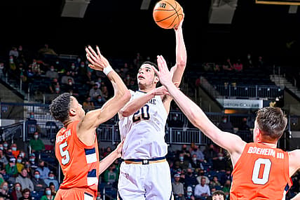 Feb 23, 2022; South Bend, Indiana, USA; Notre Dame Fighting Irish forward Paul Atkinson Jr. (20) shoots over Syracuse Orange center Frank Anselem (5) in the first half at the Purcell Pavilion. Mandatory Credit: Matt Cashore-USA TODAY Sports