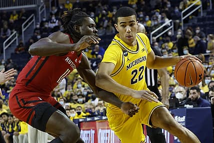 Feb 23, 2022; Ann Arbor, Michigan, USA; Michigan Wolverines forward Caleb Houstan (22) dribbles the ball against Rutgers Scarlet Knights center Clifford Omoruyi (11) in the first half at Crisler Center. Mandatory Credit: Rick Osentoski-USA TODAY Sports