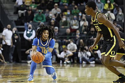 Feb 24, 2022; Eugene, Oregon, USA; UCLA Bruins guard Tyger Campbell (10) looks to pass while defended by Oregon Ducks forward Eric Williams Jr. (50) during the second half at Matthew Knight Arena. Mandatory Credit: Soobum Im-USA TODAY Sports