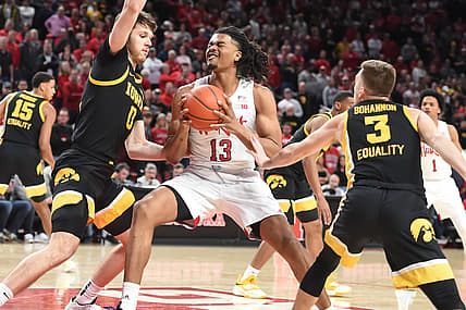Feb 25, 2022; Lincoln, Nebraska, USA;  Nebraska Cornhuskers forward Derrick Walker (13) drives between Iowa Hawkeyes guard Jordan Bohannon (3) and forward Filip Rebraca (0) in the first half at Pinnacle Bank Arena. Mandatory Credit: Steven Branscombe-USA TODAY Sports