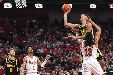 Feb 25, 2022; Lincoln, Nebraska, USA;  Iowa Hawkeyes forward Keegan Murray (15) scores against Nebraska Cornhuskers forward Derrick Walker (13) in the second half at Pinnacle Bank Arena. Mandatory Credit: Steven Branscombe-USA TODAY Sports