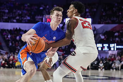 Feb 26, 2022; Athens, Georgia, USA; Florida Gators forward Colin Castleton (12) tries to get to the basket defended by Georgia Bulldogs guard Braelen Bridges (23) during the first half at Stegeman Coliseum. Mandatory Credit: Dale Zanine-USA TODAY Sports