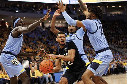 Feb 26, 2022; Milwaukee, Wisconsin, USA;  Butler Bulldogs guard Aaron Thompson (2) looks to pass the ball around Marquette Golden Eagles forward David Joplin (23) during the first half at Fiserv Forum. Mandatory Credit: Jeff Hanisch-USA TODAY Sports