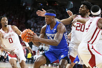 Feb 26, 2022; Fayetteville, Arkansas, USA; Kentucky Wildcats forward Oscar Tshiebwe (34) drives to the basket as Arkansas Razorbacks guard Stanley Umude (0) and forward Kamani Johnson (20) defend in the first half at Bud Walton Arena. Mandatory Credit: Nelson Chenault-USA TODAY Sports