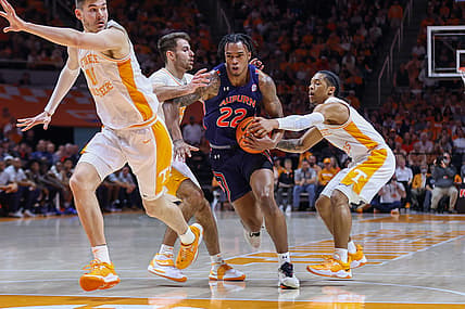 Feb 26, 2022; Knoxville, Tennessee, USA; Auburn Tigers guard Allen Flanigan (22) moves the ball against Tennessee Volunteers guard Santiago Vescovi (25) and guard Zakai Zeigler (5) during the first half at Thompson-Boling Arena. Mandatory Credit: Randy Sartin-USA TODAY Sports