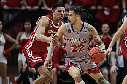 Feb 26, 2022; Piscataway, New Jersey, USA; Rutgers Scarlet Knights guard Caleb McConnell (22) dribbles against Wisconsin Badgers guard Johnny Davis (1) during the first half at Jersey Mike's Arena. Mandatory Credit: Vincent Carchietta-USA TODAY Sports