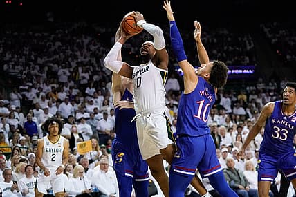 Feb 26, 2022; Waco, Texas, USA;  Baylor Bears forward Flo Thamba (0) shoots against Kansas Jayhawks forward Jalen Wilson (10) during the first half at Ferrell Center. Mandatory Credit: Chris Jones-USA TODAY Sports