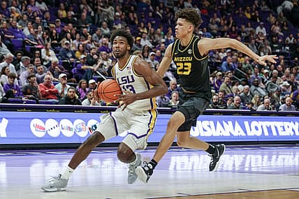Feb 26, 2022; Baton Rouge, Louisiana, USA;  LSU Tigers forward Tari Eason (13) drives to the basket against Missouri Tigers forward Trevon Brazile (23) during the first half at the Pete Maravich Assembly Center. Mandatory Credit: Stephen Lew-USA TODAY Sports