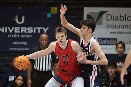 Feb 26, 2022; Moraga, California, USA; Saint Mary's Gaels center Mitchell Saxen (10) handles the ball while being defended by Gonzaga Bulldogs center Chet Holmgren (34) during the first half at University Credit Union Pavilion. Mandatory Credit: Darren Yamashita-USA TODAY Sports