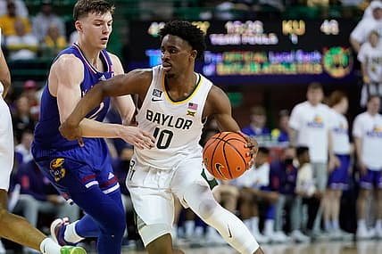 Feb 26, 2022; Waco, Texas, USA; Baylor Bears guard Adam Flagler (10) controls the ball against Kansas Jayhawks guard Christian Braun (2) during the second half at Ferrell Center. Mandatory Credit: Chris Jones-USA TODAY Sports