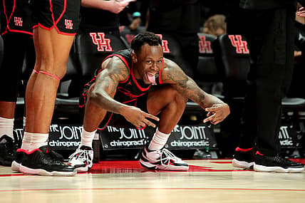 Feb 27, 2022; Houston, Texas, USA; Houston Cougars guard Taze Moore (4) celebrates from the bench after a made basket against the Southern Methodist Mustangs during the second half at Fertitta Center. Mandatory Credit: Erik Williams-USA TODAY Sports